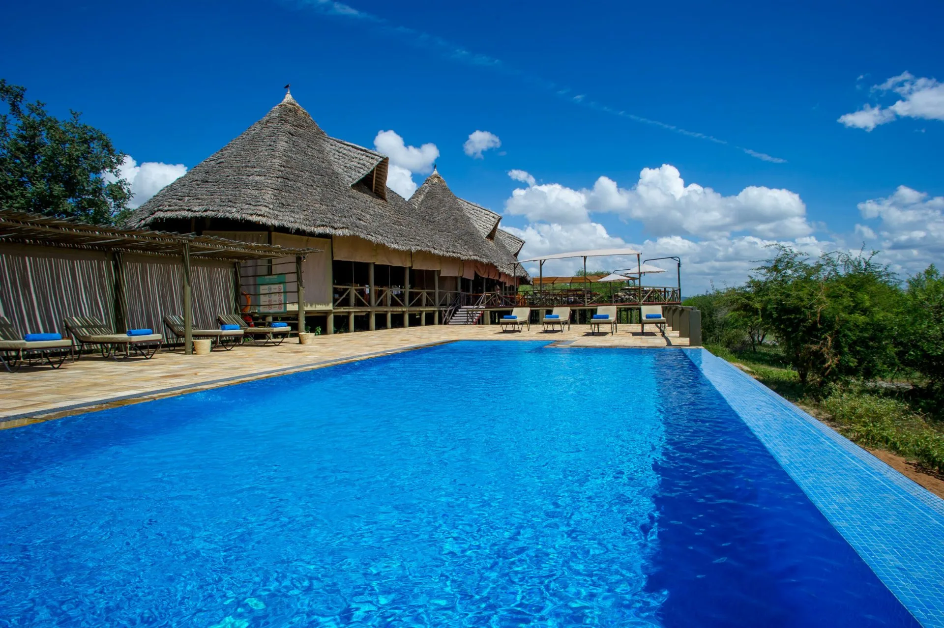 Swimming pool and thatched main lodge at Lake Burunge Tented Lodge near Tarangire