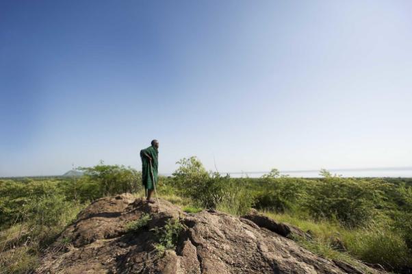 Maasai guide on a rocky outcrop above Lake Burunge near Tarangire National Park