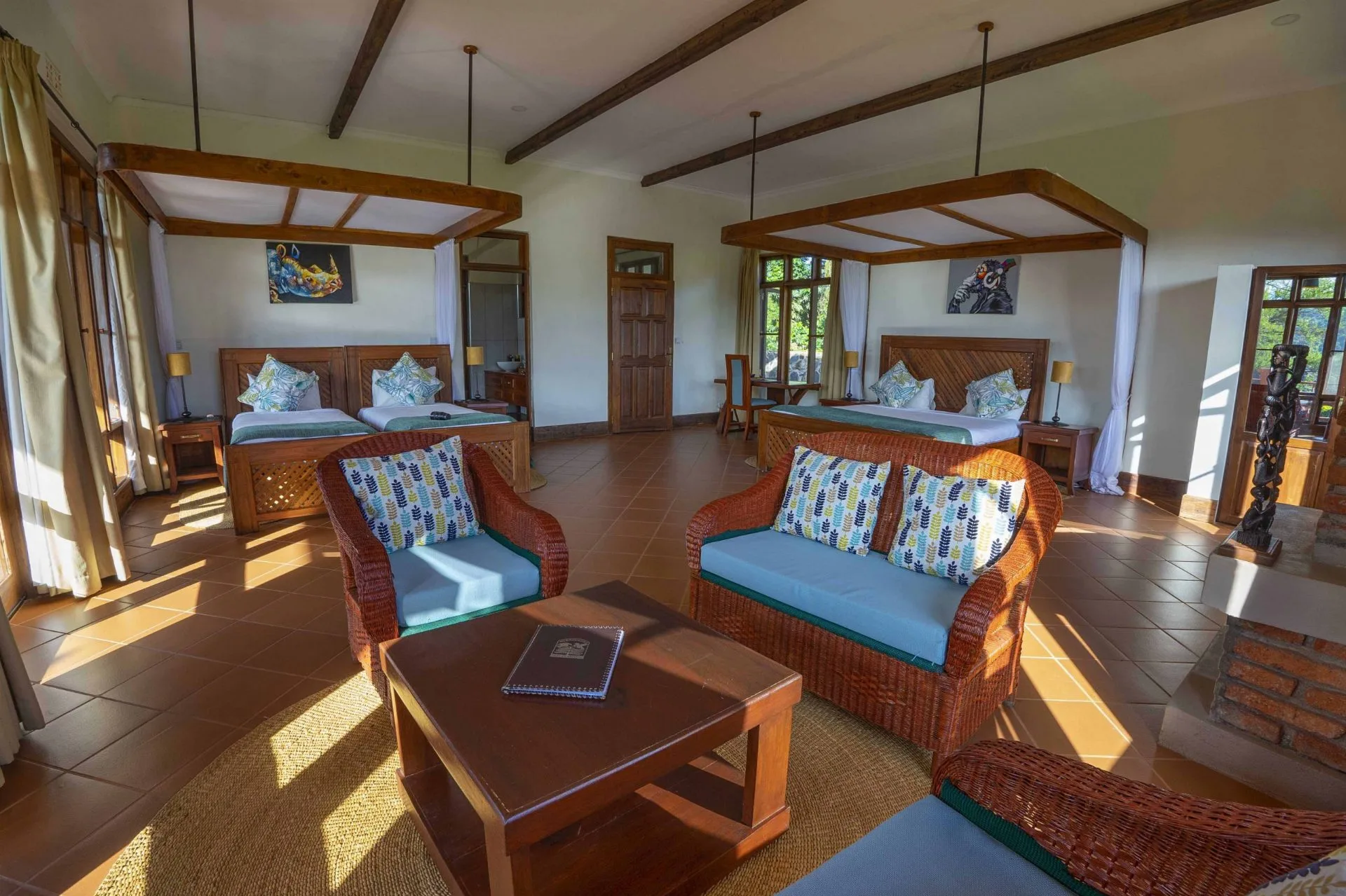 Spacious cottage with two beds and seating area at Ngorongoro Coffee Lodge, Karatu