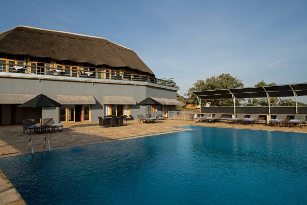 Swimming pool and thatched main building at Kubu Kubu Tented Lodge, central Serengeti