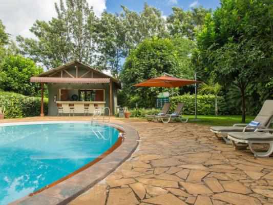 Swimming pool in the gardens at Arusha Planet Lodge