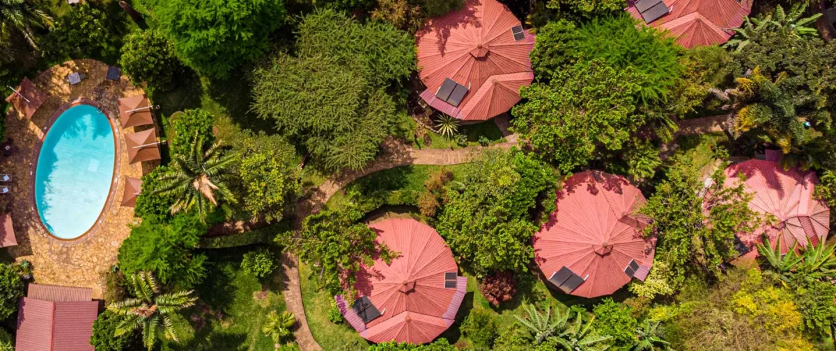 Aerial view of the rondavel rooms among the gardens at Arusha Planet Lodge