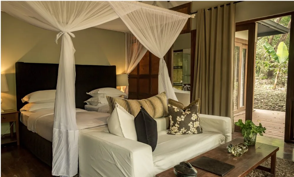 Bedroom and lounge in a chalet at Lake Duluti Lodge