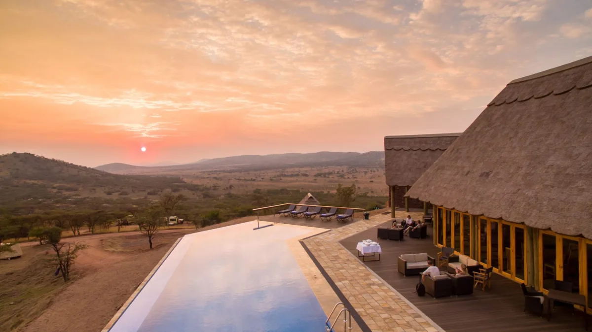 Pool deck at dusk at Lahia Tented Lodge