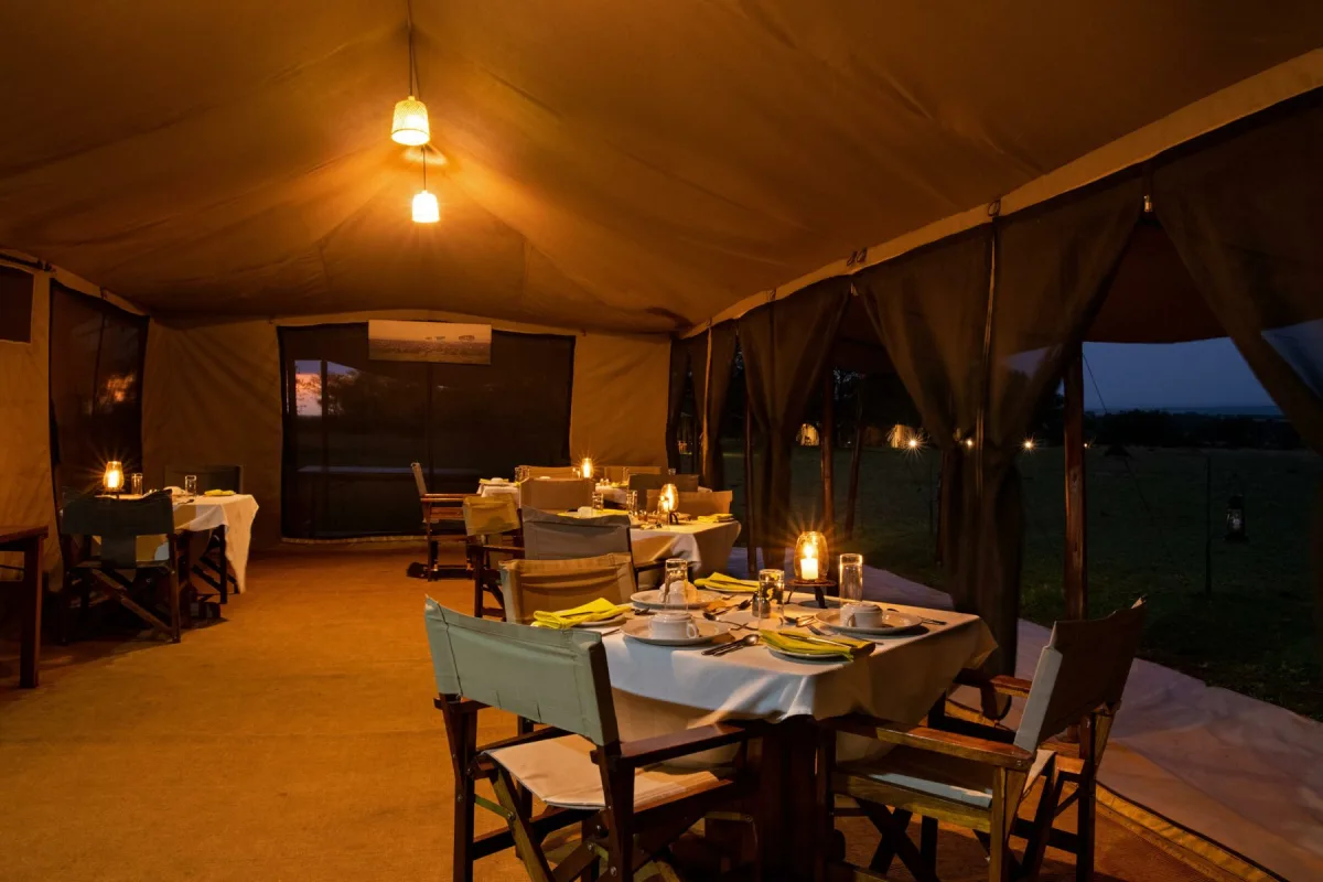 Mess tent set for dinner at Mara Under Canvas