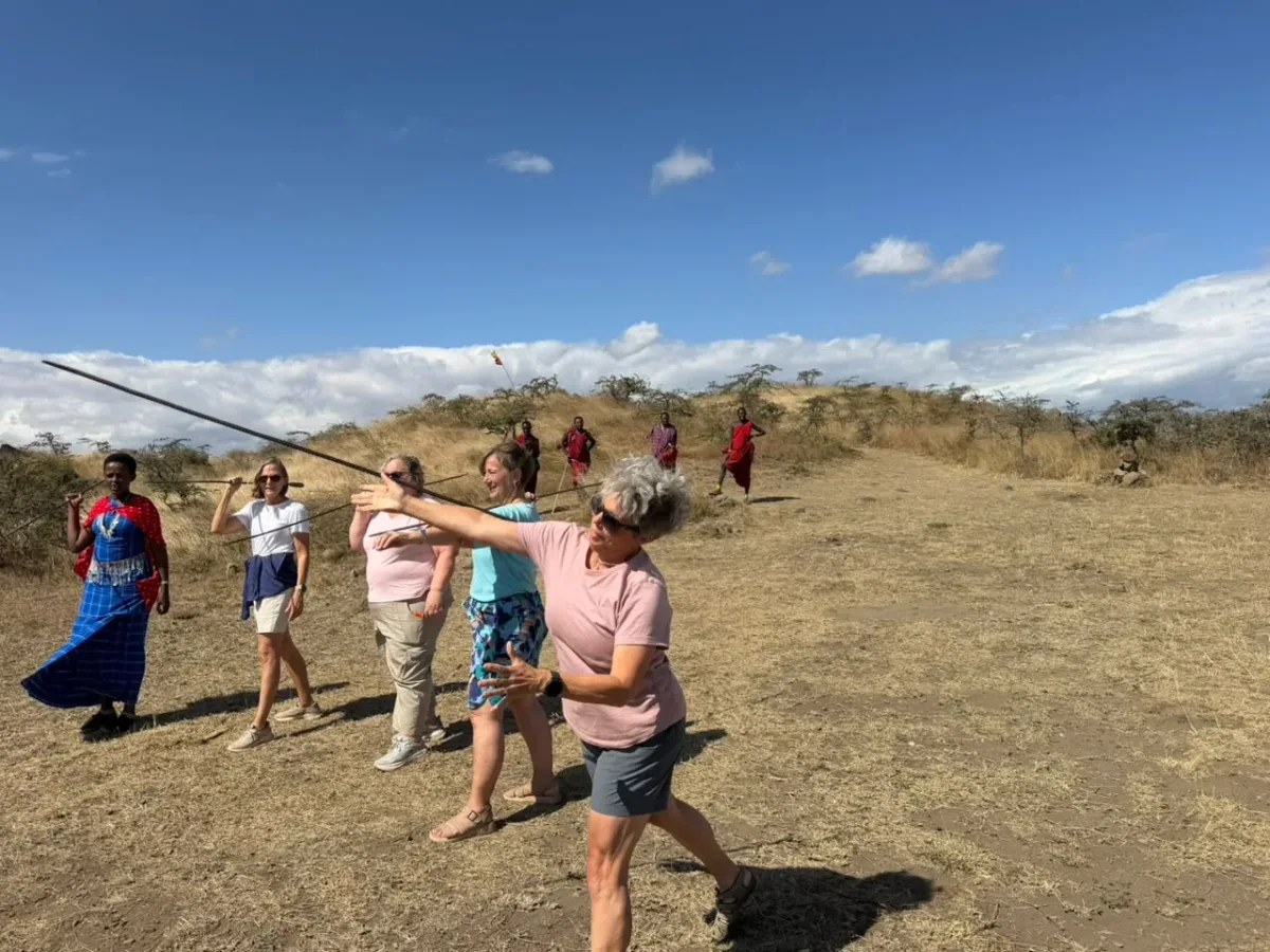 Guests learning to throw a spear with Maasai warriors