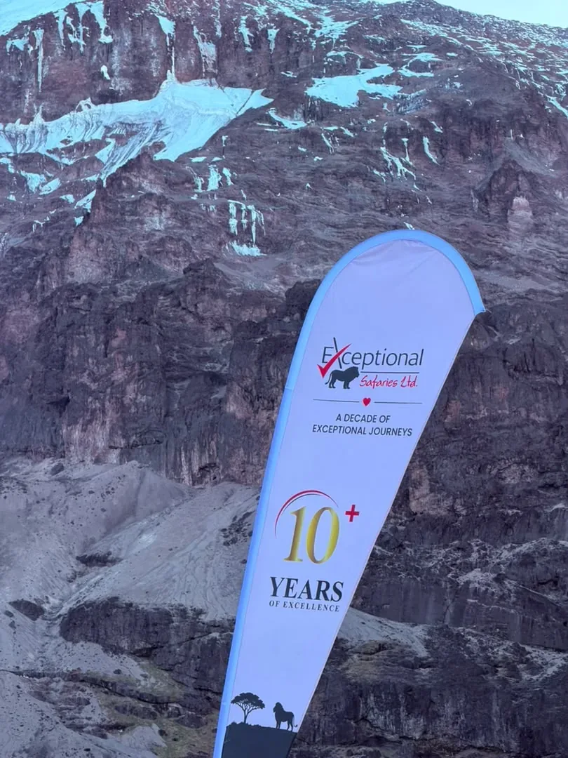 Kilimanjaro – The Exceptional Safaries 10 Years flag below Kibo’s glaciers