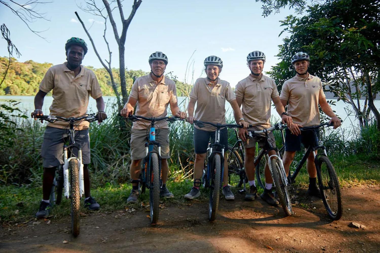 The group with their bikes on the shore of Lake Duluti