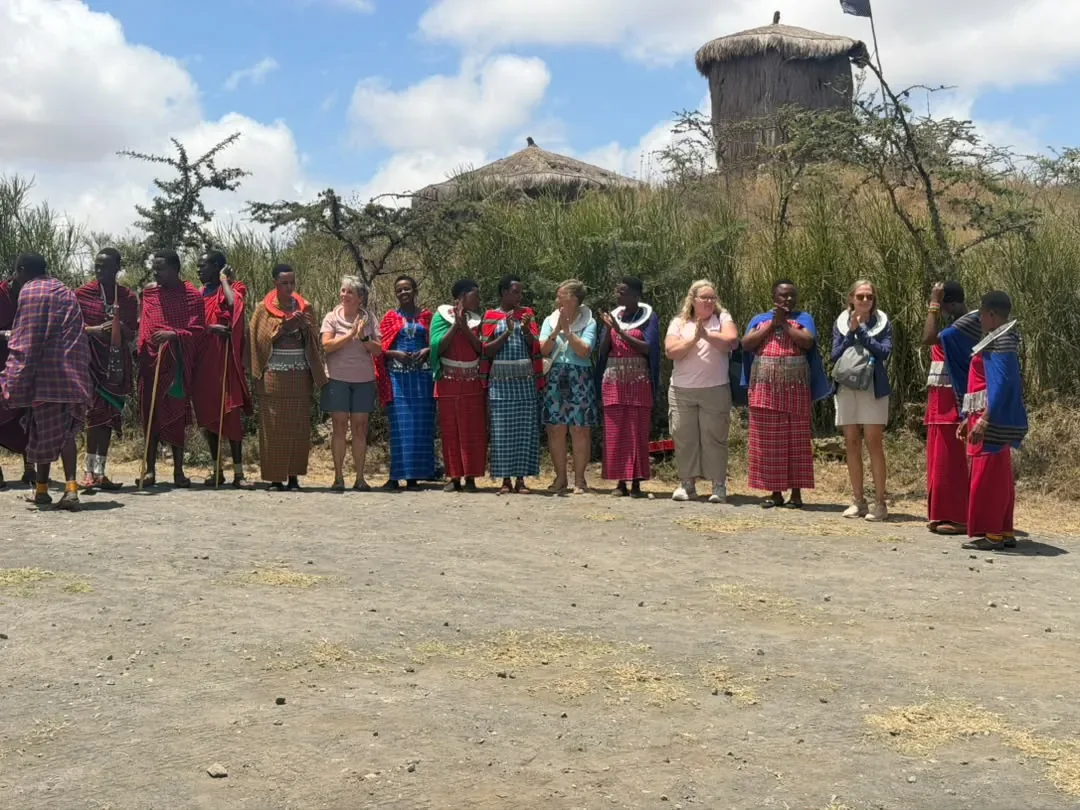 Maasai men and women singing a welcome for guests at Osiligilai