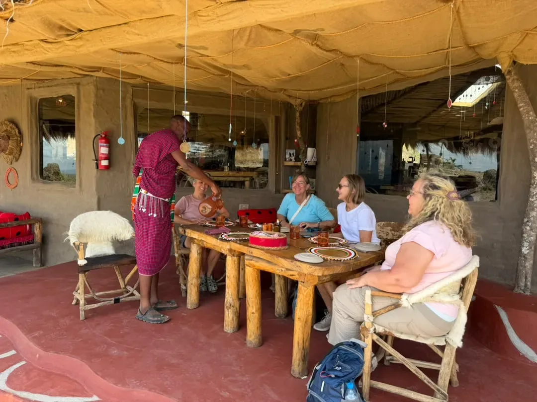 Guests at lunch in the Osiligilai dining room with their Maasai host