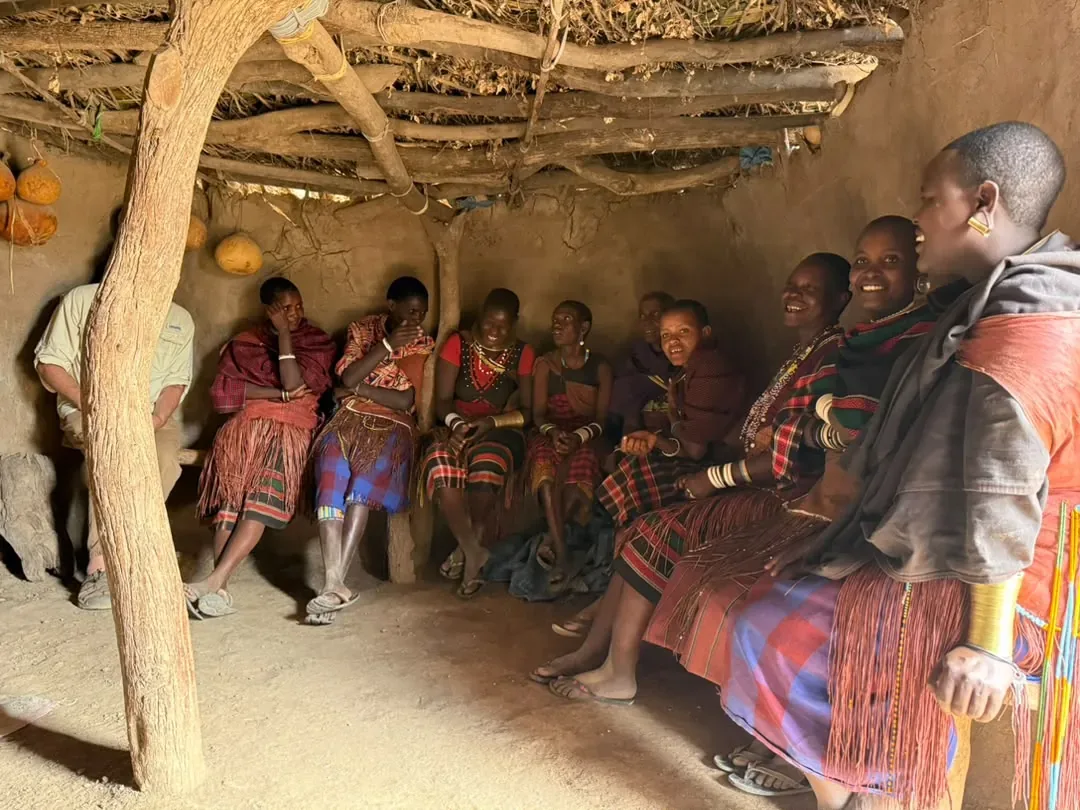 Lake Eyasi – Datoga women and a guest sitting inside a Datoga home