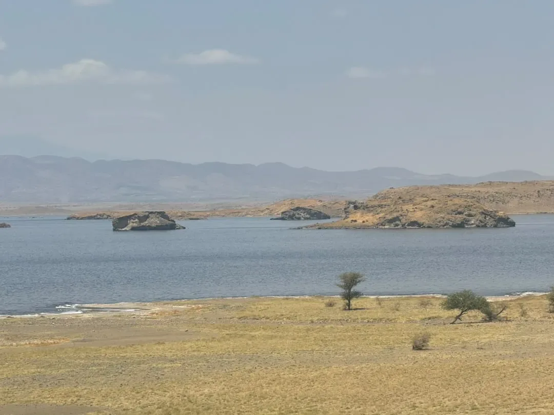 Rocky islands on Lake Natron below the Rift Valley hills